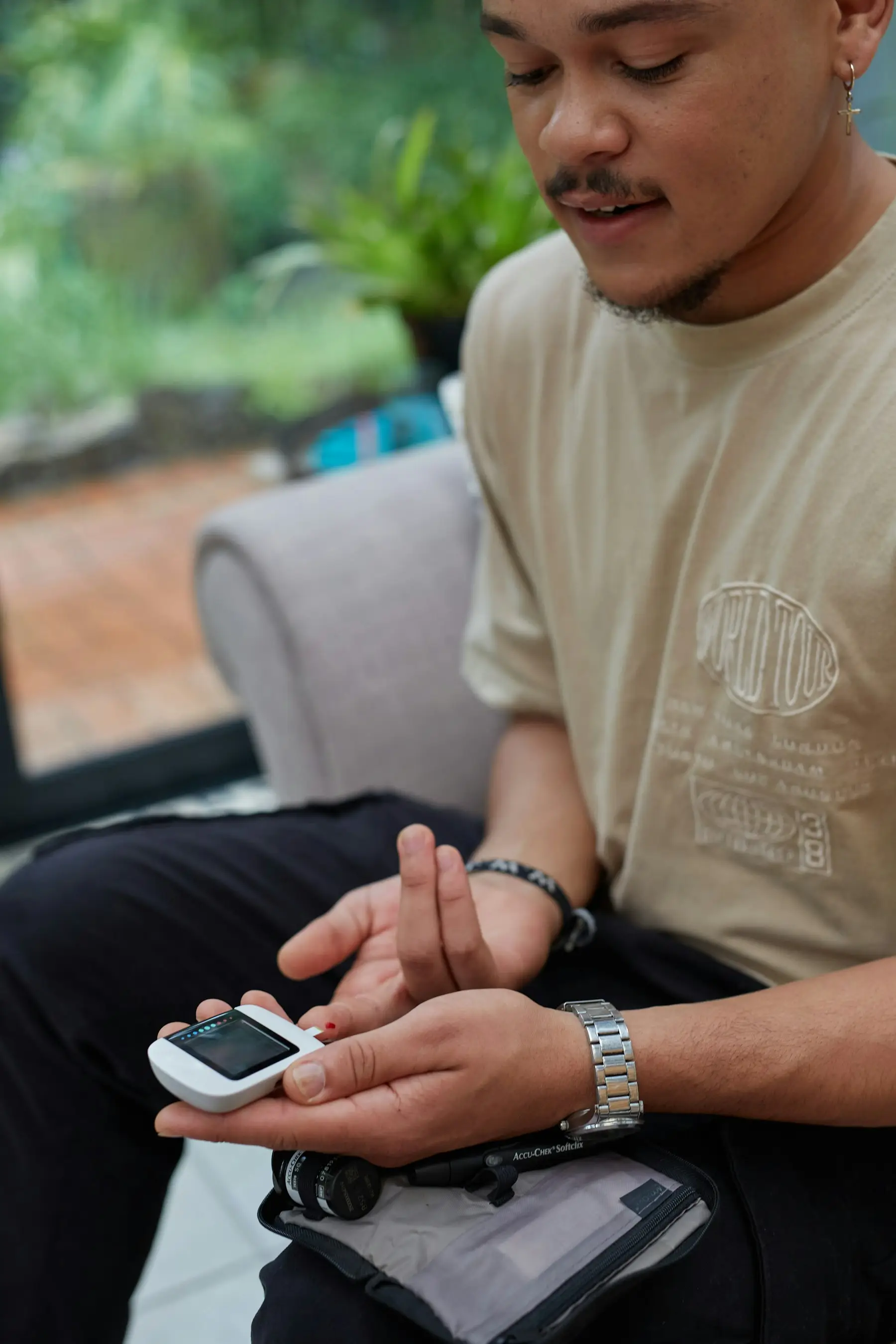 A young man receiving a blood sugar screening at a health check